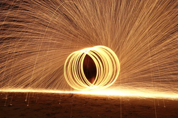 Skill Man playing fireworks by spinning wood pole with fuel oil — Stock Photo, Image