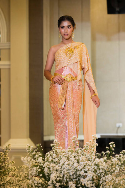 Bangkok, Thailand - February 24, 2019 ; Fashion Model in Thai Traditional Costume Wedding Dress present on Catwalk Runway in Mandarin Hotel for Wedding Fair for new Lovers to select dress, planner