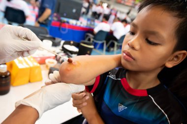 Bangkok, Thailand - July 27, 2019 ; Sport Event named Heroes TaeKwonDo International Championship 2019. Nurse EMS first aid injuries player accident at arms and pain at Assumption University