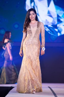 Udonthani, Thailand - July 23, 2019 ; Miss Thailand 2019 Udonthani, Beautiful Contestants present fashion show on stage with evening gown Colorful Dress Costume at Montatip Hall