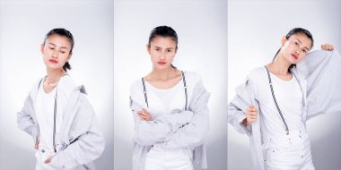 Kolaj Grubu 'nun Moda Genç Asyalı Sıska Kadın Paketi beyaz gömlek askısı takıyor ve çekici bir görünüm sergiliyor. Stüdyo Işıklandırma beyaz Arkaplan tecrit edilmiş telif alanı
