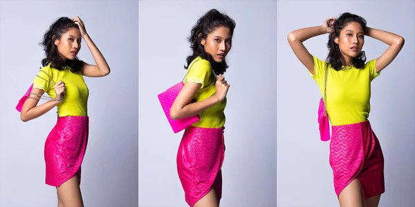 20多岁的年轻亚洲女子作为时装模特 身穿绿色衬衫和霓虹灯粉色短裙 手持硅胶别针手袋钱包离合器 工作室照明灰色背景隔离 拼贴团体包装肖像 — 图库照片