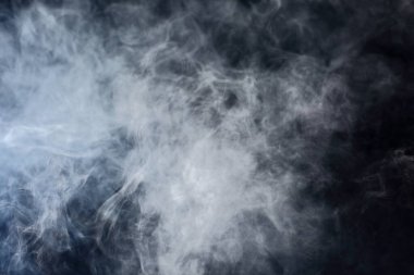 Dense Fluffy Puffs of White Smoke and Fog on Black Background, Abstract Smoke Clouds, Movement Blurred out of focus clipart