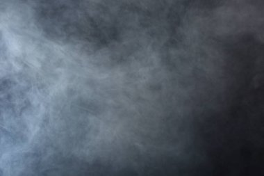 Dense Fluffy Puffs of White Smoke and Fog on Black Background, Abstract Smoke Clouds, Movement Blurred out of focus clipart