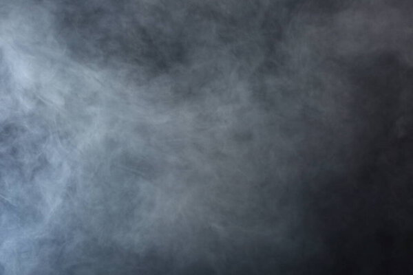 Dense Fluffy Puffs of White Smoke and Fog on Black Background, Abstract Smoke Clouds, Movement Blurred out of focus