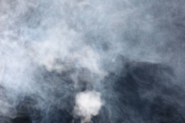 Dense Fluffy Puffs of White Smoke and Fog on Black Background, Abstract Smoke Clouds, Movement Blurred out of focus