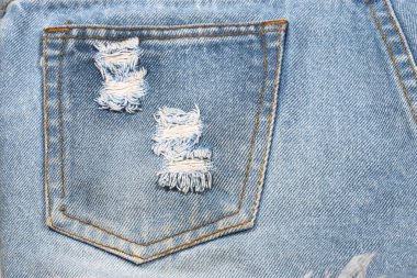 Kotun kumaş dokusu arka plan, kısa mavi kot pantolonun bir kısmı, çizik izleri kayboluyor.