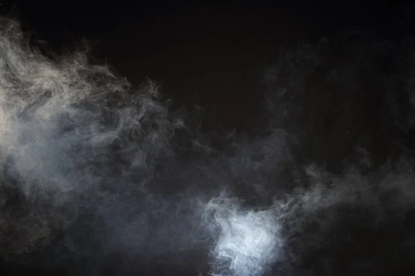 Dense Fluffy Puffs of White Smoke and Fog on Black Background, Abstract Smoke Clouds, All Movement Blurred, intention out of focus, and high low exposure contrast, copy space for text logo