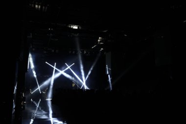 Empty Runway Fashion Show catwalk with moving beam lighting along walk way, background stage ramp