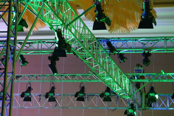 Performance moving lighting on construction light beam ray downward in yellow blue color, on Concert and Fashion Show stage ramp