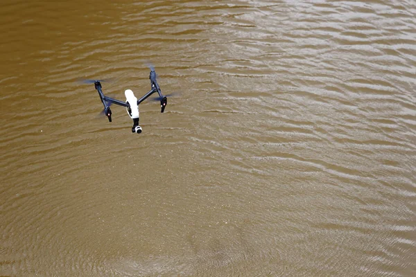 Drone in the Air over brown river water and wave from wind, blur movement