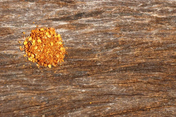 Red Hot Spice Powder on Wood Surface, Bark of antique  old Tree with copy space for text and logo