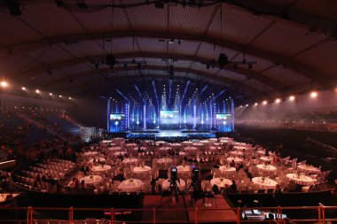 Krinica, Poland - December 02, 2017 ; Mister Supranational 2017, World Contest at Hotel Krinica, Empty Runway Fashion Show with LCD LED Screen lighting, background stage ramp Gala Dinner table VIP