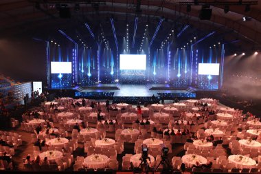 Krinica, Poland - December 02, 2017 ; Mister Supranational 2017, World Contest at Hotel Krinica, Empty Runway Fashion Show with LCD LED Screen lighting, background stage ramp Gala Dinner table VIP