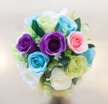 Rengarenk bir buket çiçeğin üst görüntüsü kavanozun üzerinde suni, stüdyo beyaz arka plan aydınlatıyor.