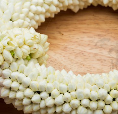 El ele tutuşmak için yuvarlak, küçük, yuvarlak bir çiçek şeklinde pek çok beyaz çiçek, ahşap masa üzerine dizilmiş, stüdyo beyaz arka plan fotokopi alanı aydınlatma metin logosu, 