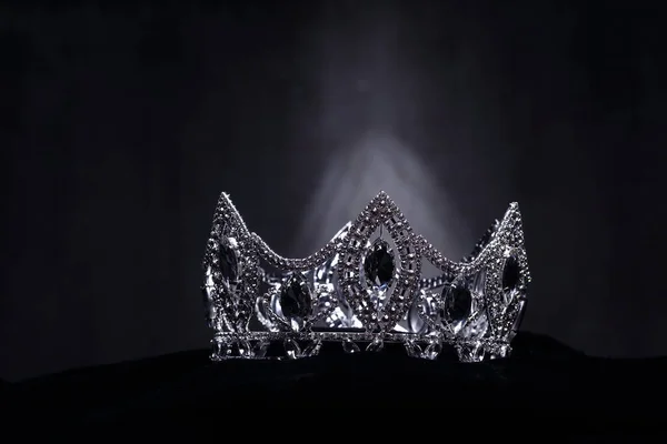 Diamond Silver Crown for Miss Pageant Beauty Contest, Crystal Tiara jewelry decorated gems stone and abstract dark background on black velvet fabric cloth, Macro photography copy space for text logo