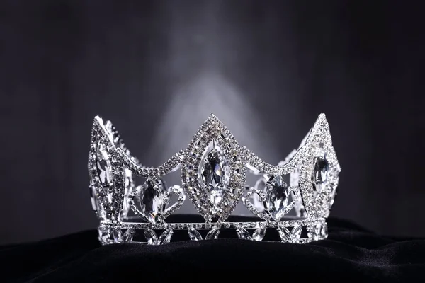 Diamond Silver Crown for Miss Pageant Beauty Contest, Crystal Tiara jewelry decorated gems stone and abstract dark background on black velvet fabric cloth, Macro photography copy space for text logo