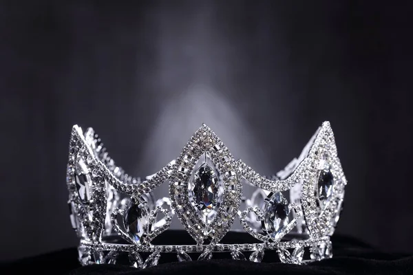 Diamond Silver Crown for Miss Pageant Beauty Contest, Crystal Tiara jewelry decorated gems stone and abstract dark background on black velvet fabric cloth, Macro photography copy space for text logo