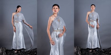 Tayland Geleneksel Kostümünün Mavi Gümüş Elbisesi ya da Güneydoğu Asya Altın Elbisesi. Asyalı Kadın Elbisesi Stüdyo 'nun gri arka planı altında birçok poz veriyor.