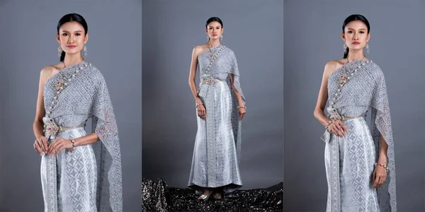 Blue Silver Dress of Thai Traditional Costume or South East Asia gold Dress in Asian Woman with decoration stand in many poses under Studio lighting grey background, collage group pack