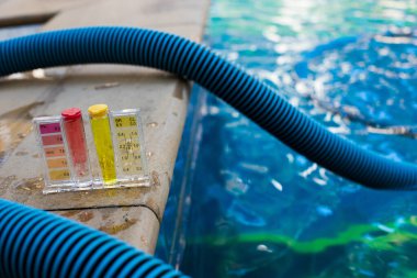 Equipment PH Test Kit on swimming pool chlorine and fresh river water inspector. Procedure to check day week level of safety in pool water to make sure water is clean and can swim clipart