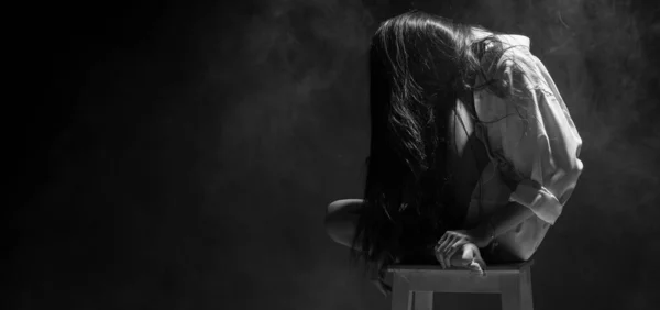 White Smoke Tan Skin Asian Woman black straight hair with Dense Fluffy Puffs of Fog on dark Background, Abstract high low exposure contrast, copy space for text logo, broken heart lonely girl can cry