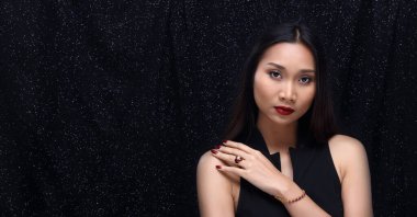 Siyah arka planda Güzellik Moda Cazibesi Asyalı Kız Portresi. Eski tarz takı takan kız. Güzel, uzun düz saç stili ve mükemmel makyaj. Seksi Kızıl Dudaklar. Elmas kalp şekli Yüzük.