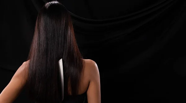 アジアの女性の背中側のビュー長い髪を保持キッチン鋭いナイフ手で スタジオの照明黒の背景 ストライキによって裏切る準備ができて — ストック写真