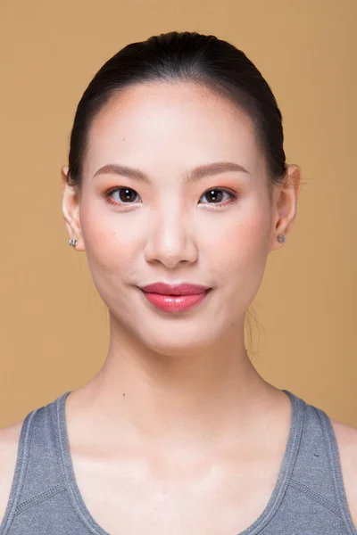 適用後のアジアの女性は ラップヘアスタイルを構成します レタッチなしにきび 素敵な滑らかな肌で新鮮な顔 スタジオ照明黄色ベージュマスタード背景 美学療法のための — ストック写真