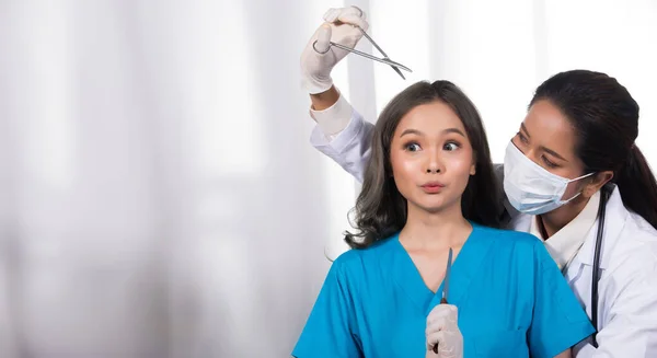 Asian Patient was checked health by india middle east Doctor woman in uniform with stethoscope, rubber gloves in Medical hospital clinic, concept rhinoplastry check before plastic surgery, copy space