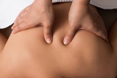 Mix Race Kafkas Asyalı bir kadının çıplak sırtına masaj yapmak. Rahatlamak için parmaklarını acının üzerine bastırmak ya da stres yapmak. Terapist Spa vücut masajcısı kadın müşteriye elini uzattı