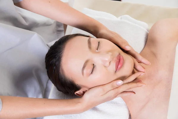 Ayurvedic Head Massage Therapy on facial forehead Master Chakra Point of Asian woman, Therapist Spa body woman hands treatment on customer to increase circulation release tension stress of think work