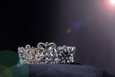 Diamond Silver Crown for Miss Pageant Beauty Contest, Crystal Tiara jewelry decorated gems stone and abstract dark background on black velvet fabric cloth, Macro photography copy space for text logo