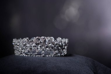 Diamond Silver Crown for Miss Pageant Beauty Contest, Crystal Tiara jewelry decorated gems stone and abstract dark background on black velvet fabric cloth, Macro photography copy space for text logo