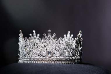 Diamond Silver Crown for Miss Pageant Beauty Contest, Crystal Tiara jewelry decorated gems stone and abstract dark background on black velvet fabric cloth, Macro photography copy space for text logo