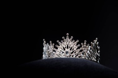 Diamond Silver Crown for Miss Pageant Beauty Contest, Crystal Tiara jewelry decorated gems stone and abstract dark background on black velvet fabric cloth, Macro photography copy space for text logo