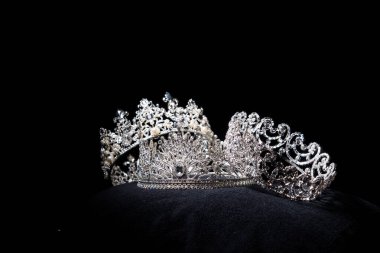 Diamond Silver Crown for Miss Pageant Beauty Contest, Crystal Tiara jewelry decorated gems stone and abstract dark background on black velvet fabric cloth, Macro photography copy space for text logo