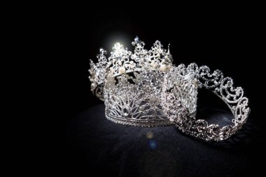 Diamond Silver Crown for Miss Pageant Beauty Contest, Crystal Tiara jewelry decorated gems stone and abstract dark background on black velvet fabric cloth, Macro photography copy space for text logo
