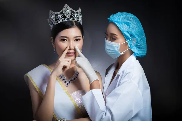 Miss Beauty Queen Pageant Contest with Diamond crown sash is checked up by Beautician Doctor and recommend consult before Plastic Surgery, skin treatment, adjust face cheek bone rhinoplasty eyes lips