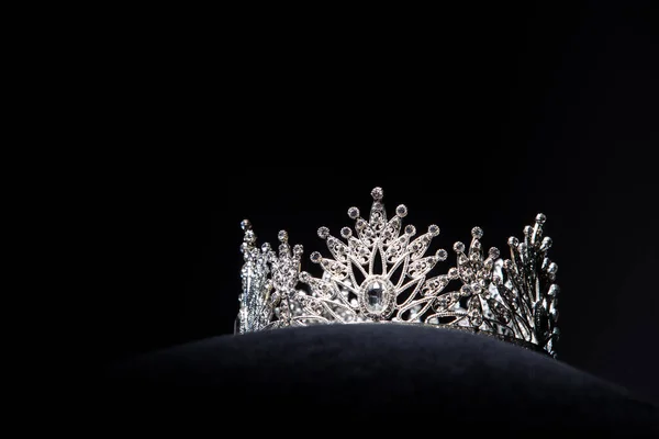 Diamond Silver Crown for Miss Pageant Beauty Contest, Crystal Tiara jewelry decorated gems stone and abstract dark background on black velvet fabric cloth, Macro photography copy space for text logo