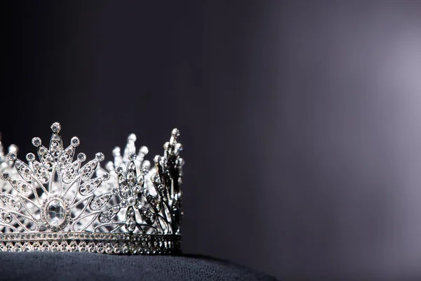 Diamond Silver Crown for Miss Pageant Beauty Contest, Crystal Tiara jewelry decorated gems stone and abstract dark background on black velvet fabric cloth, Macro photography copy space for text logo