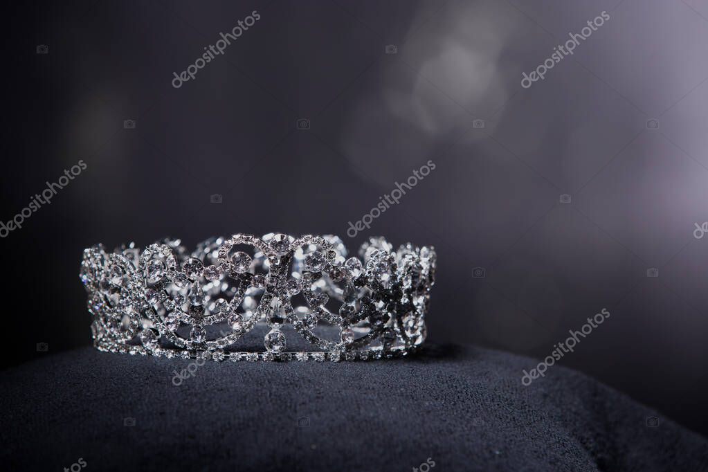 Diamond Silver Crown for Miss Pageant Beauty Contest, Crystal Tiara jewelry decorated gems stone and abstract dark background on black velvet fabric cloth, Macro photography copy space for text logo