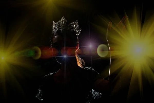 Portrait Silhouette Shadow Back Rim Light of Miss Pageant Beauty Queen Contest Silver Diamond Crown wave hand express feeling smile, studio lighting dark black background, turn front face to camera