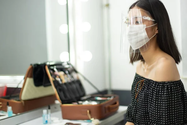 Covid New Normal change behavior of people, Woman has to wear Hygiene surgical mask and Face Shield to protect droplet Virus in Air. Young Asian girl ready to stay live with Corona covid-19