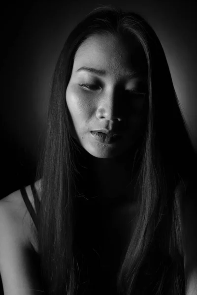 Portrait of Slim Asian Woman black straight hair, Abstract high low exposure contrast shadow, broken heart
