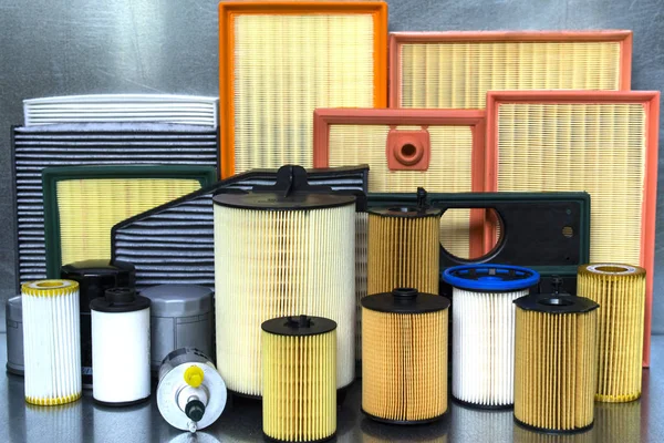 Spare parts for car. Oil filter, air filter, fuel filter, cabin filter close-up on a steel background