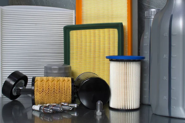 Spare parts for car. Oil filter, air filter, fuel filter, cabin filter close-up on a steel background