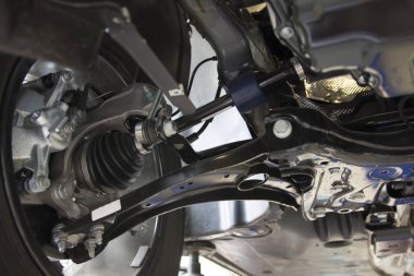 Close-up on the front suspension of a modern car. MacPherson suspension. Technical photograph