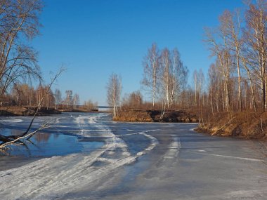 Spring Park, melting snow and ice. Russian spring nature. Russia, Ural, Perm Region